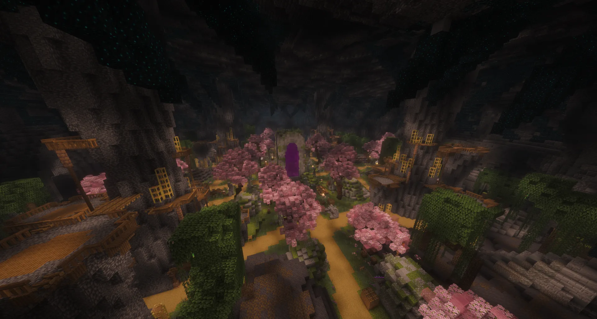 The StoneBlock 4 spawn cavern seen from above: cherry trees and wooden walkways around a purple portal arch, under a dark stone ceiling